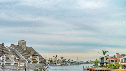 Pano Blue sky and puffy clouds over scenic waterfront neighborhood of Long Beach