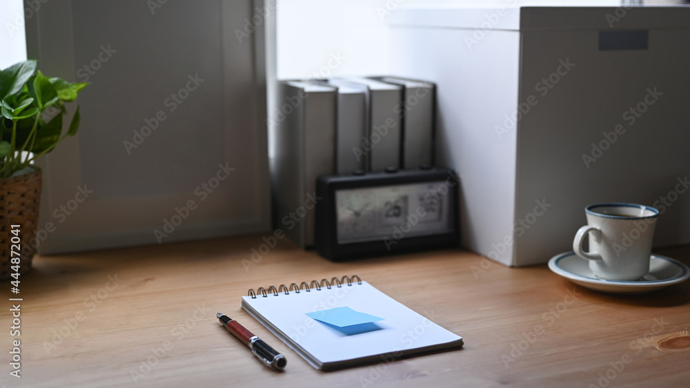 Notebook and pen on comfortable workspace. Notebook and pen on comfortable workspace.