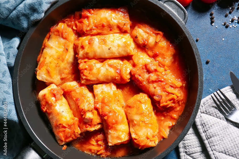 Frying pan with tasty stuffed cabbage rolls on color background Frying pan with tasty stuffed cabbage rolls on color background