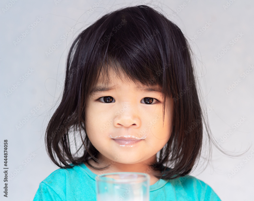 A headshot portrait of a cheerful baby Asian woman, a cute toddler little girl with adorable bangs hair, a child a smiling drinking milk and looking to the camera. A headshot portrait of a cheerful baby Asian woman, a cute toddler little girl with adorable bangs hair, a child a smiling drinking milk and looking to the camera.