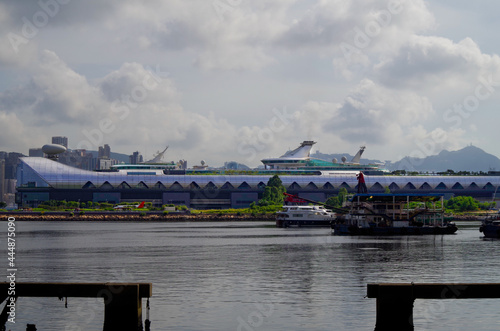 Cruiseship cruise ship liner in port of Hongkong Hong Kong, China with Kai Tak cruise terminal and city skyline photo