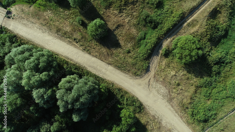 Aerial view of a field road among the bushes