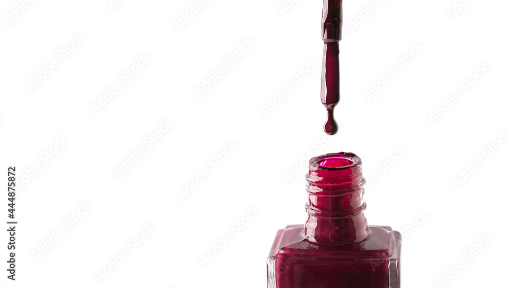 Red nail polish drop dripping from a brush into a bottle isolated on white background. Red nail polish drop dripping from a brush into a bottle isolated on white background.