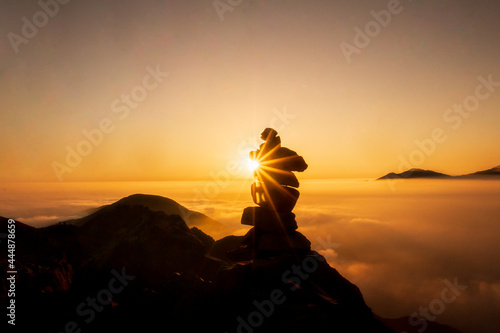 Beautiful sunset in the mountains  silhouette of stone column called Apacheta in the Andean zone of Peru.