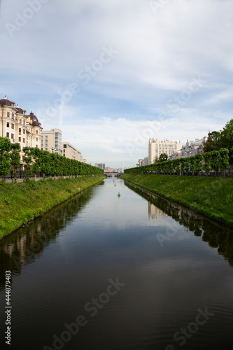 The river flows through a canal in the city. Panorama of the residential central districts of the city of Kazan across the river, Russia.