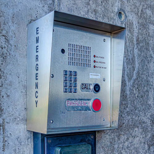 Square Emergency security box with call button mounted on the wall of campus building