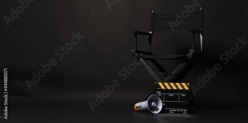 Black director chair and Clapper board or movie Clapperboard with yellow megaphone on black background.use in video production or film cinema industry