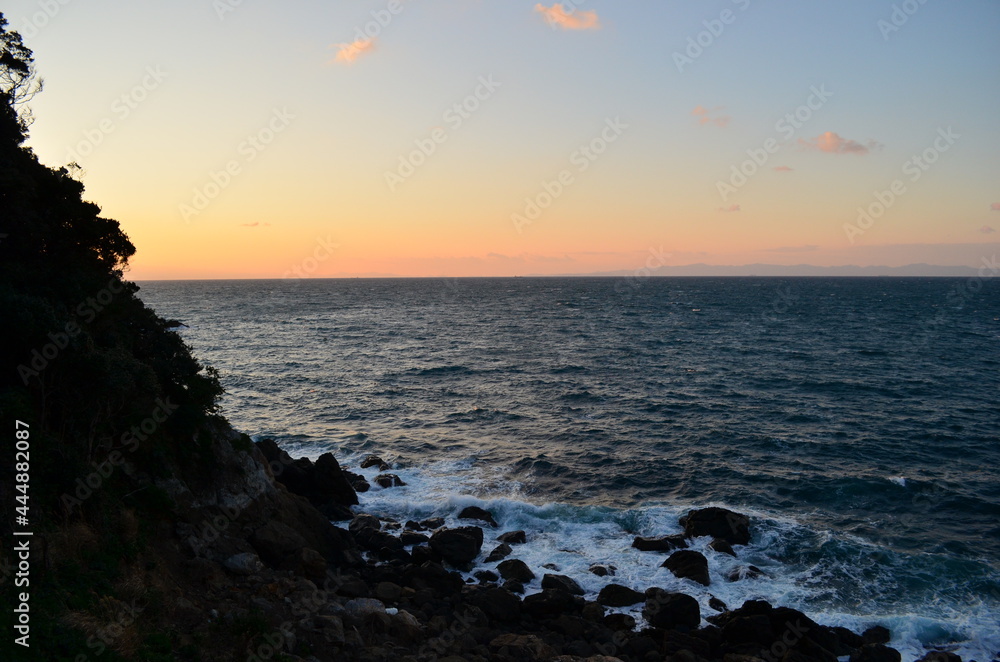 Unquiet landscape of rocks and sea sunset