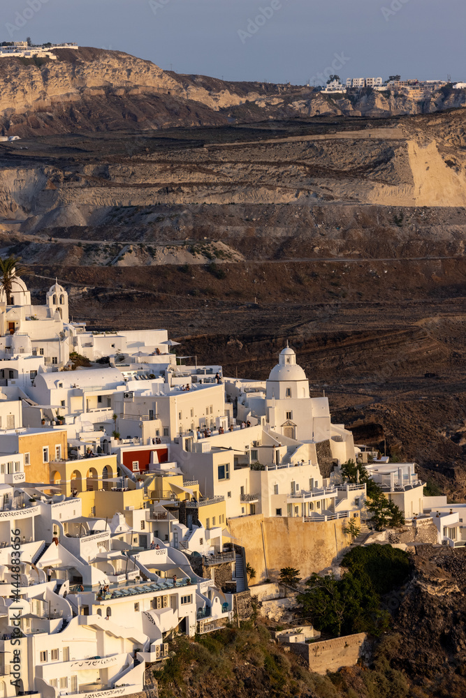  The whitewashed town of Fira in warm rays of sunset on Santorini island, Cyclades, Greece