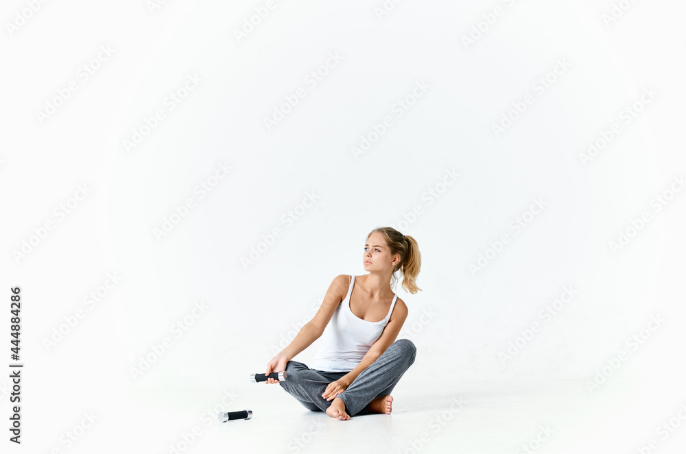 sportive woman sitting on floor with dumbbells workout muscles sportive woman sitting on floor with dumbbells workout muscles