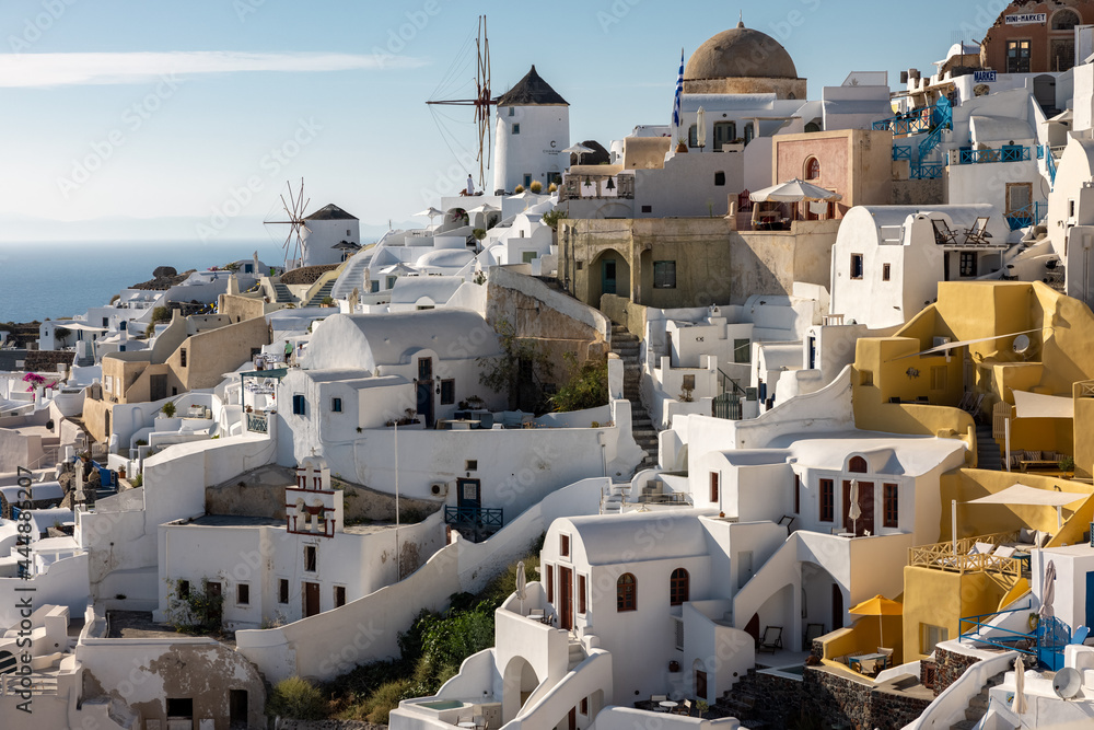 Whitewashed houses and windmills in Oia on Santorini island, Cyclades, Greece