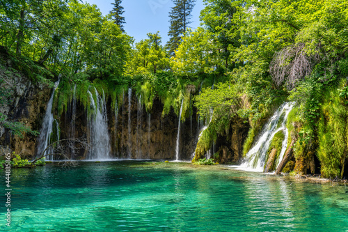 Waterfall with turquoise water in the Plitvice Lakes National Park, Croatia.