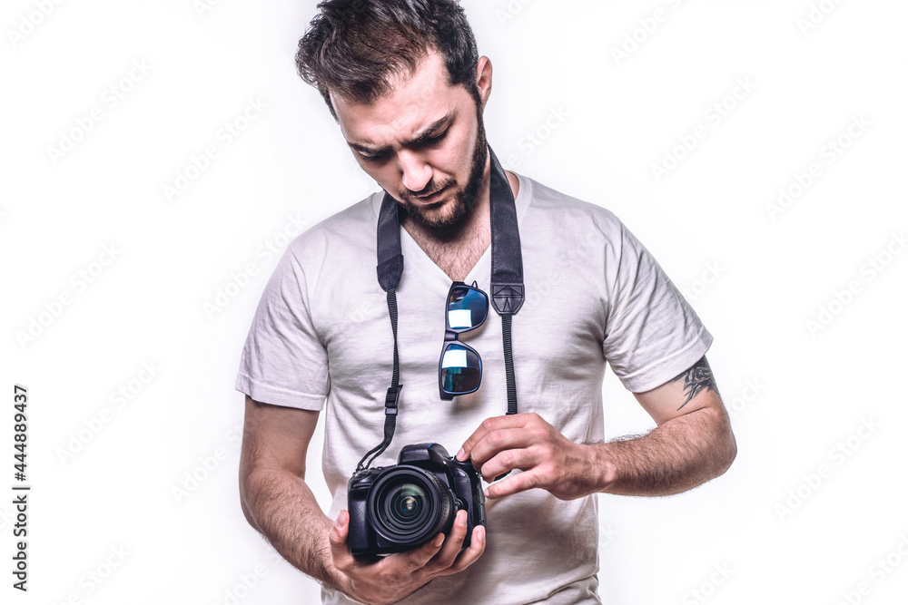 Man with camera. Hipster photographer takes photo in studio. Isolated white background Man with camera. Hipster photographer takes photo in studio. Isolated white background