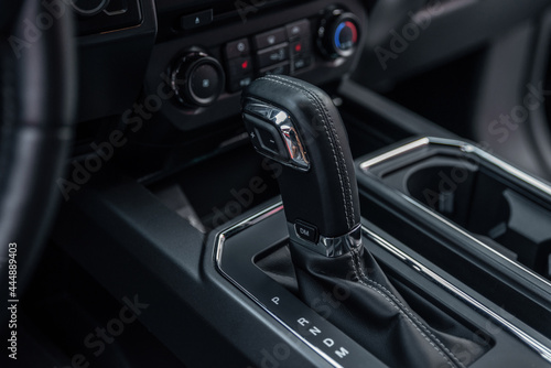Modern car inside. Control panel and automatic transmission background. Detail of an automatic gear shifter in a modern expensive car. © Oleksandr
