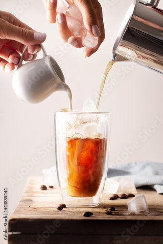 Homemade preparing of iced cofee with milk