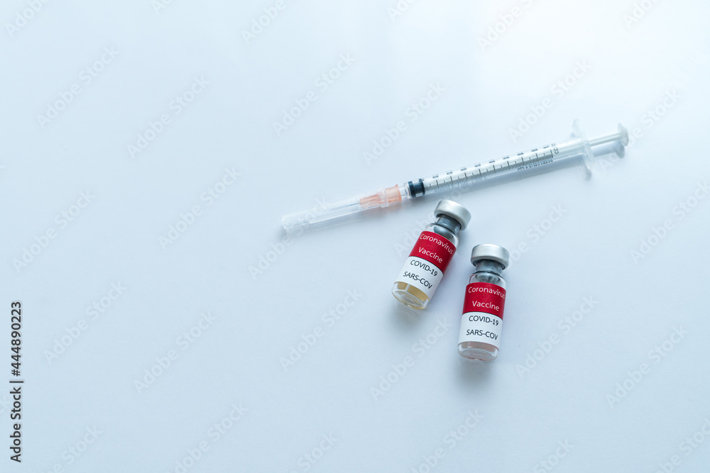 Topveiw Vaccine and syringe injection on wite background. It use for prevention,immunization and treatment from corona virus infection. Medicine infectious concept. Topveiw Vaccine and syringe injection on wite background. It use for prevention,immunization and treatment from corona virus infection. Medicine infectious concept.