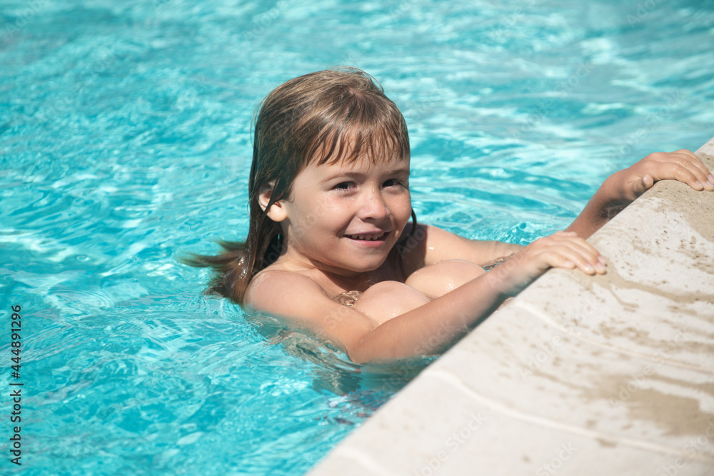 Kid boy swim in swimming pool. Kids summer vacation concept.