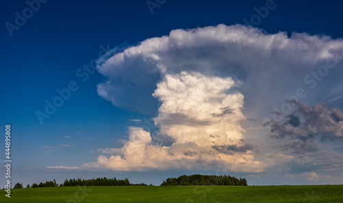 Isolated cumulonimbus storm clouds in the blue sky