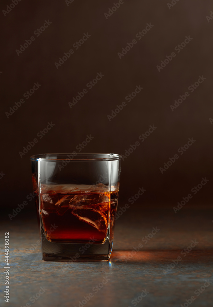 Glass of whiskey on a rusty background. Glass of whiskey on a rusty background.