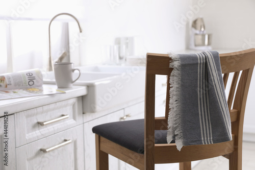 Dry towel on wooden chair in kitchen © New Africa