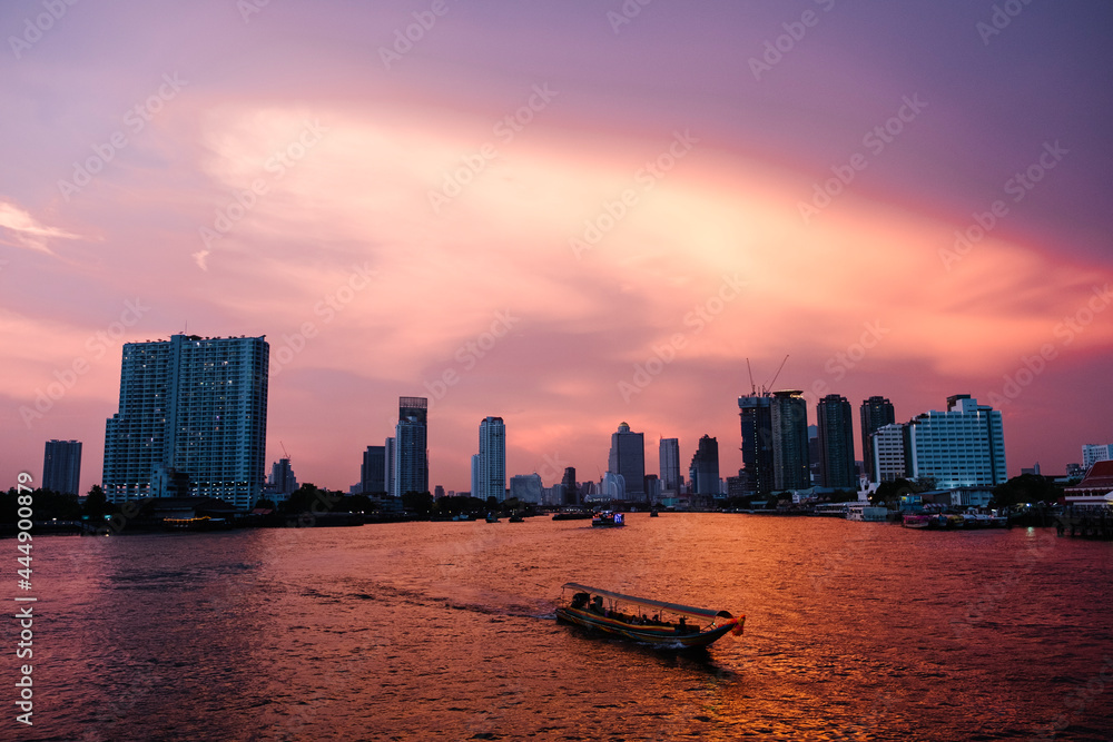 sunset river city and ferry boat in Bangkok