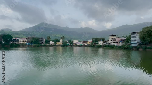 Scenic View Of Urban Landscape On Lakeshore In Trimbakeshwar City, Trimbak, Maharashtra, India. - Panning Shot photo