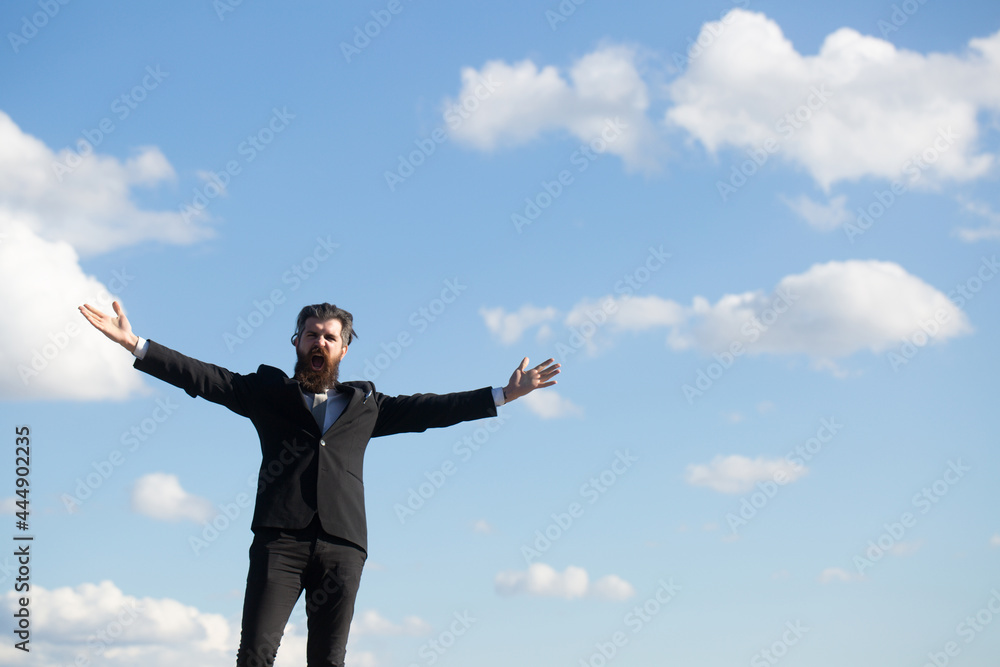 Man in suit raising hand on sky background. Freedom adventure and business victory concept. Success business and freedom. Man in suit raising hand on sky background. Freedom adventure and business victory concept. Success business and freedom.