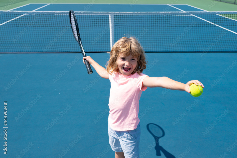 Kid tennis player on tennis court. Boy hitting forehand in tennis