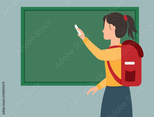 A schoolgirl writing at the chalkboard, back to school concept, flat vector illustration