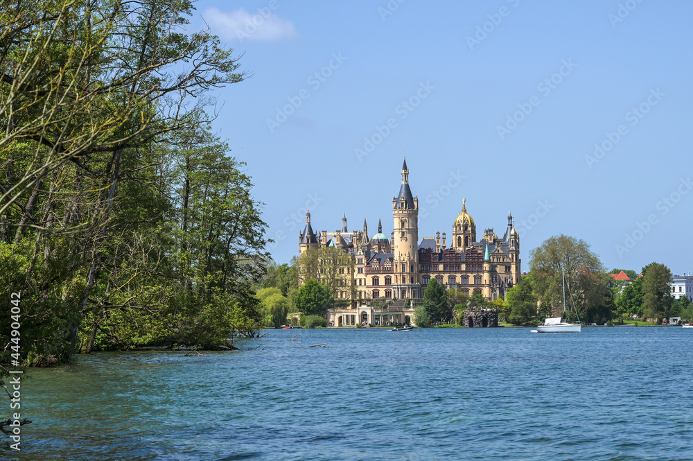 Schwerin castle against a blue sky seen from the lake, famous landmark and tourist attraction of the state capital city of Mecklenburg-Vorpommern, Germany, copy space