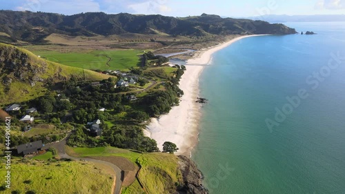 White sandy Otama beach, Coromandel Peninsula coast, aerial view of New Zealand landscape, sunny day. photo