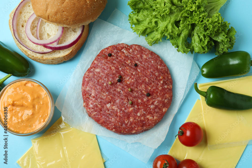 Concept of cooking burger on blue background Concept of cooking burger on blue background