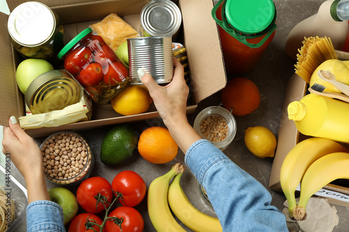 Donation concept with female hands and different food
