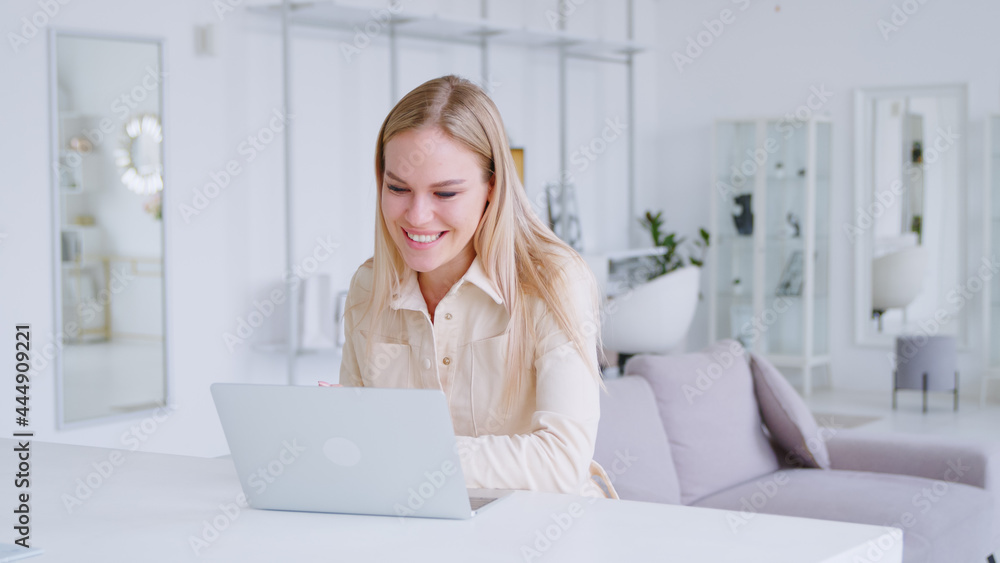 Smiling young girl communicating by video live using computer, microphone and webcam Smiling young girl communicating by video live using computer, microphone and webcam
