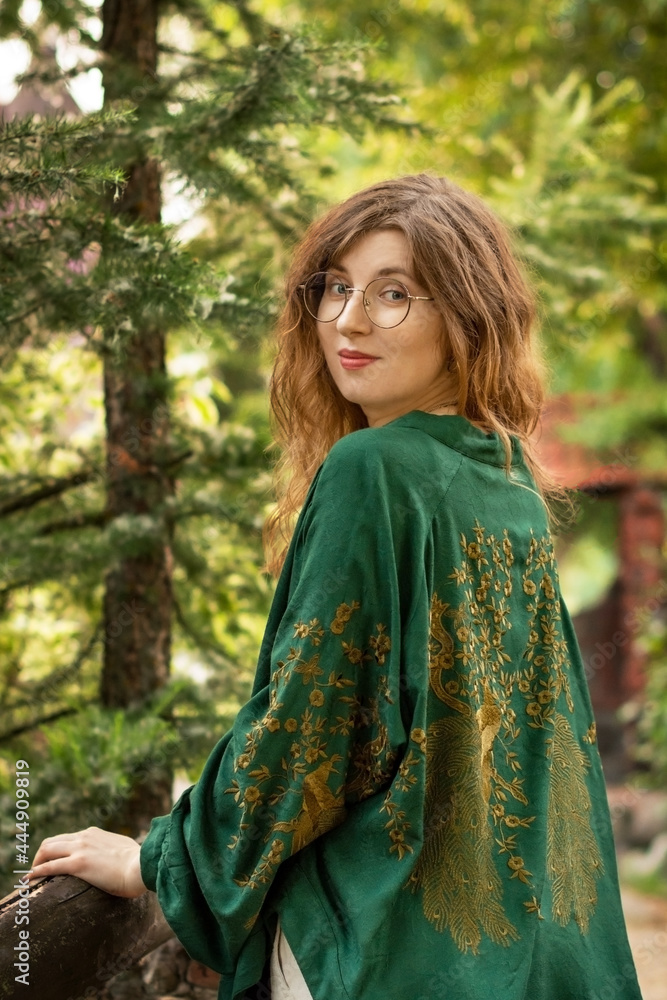 Beautiful girl in a green jacket in the park Beautiful girl in a green jacket in the park