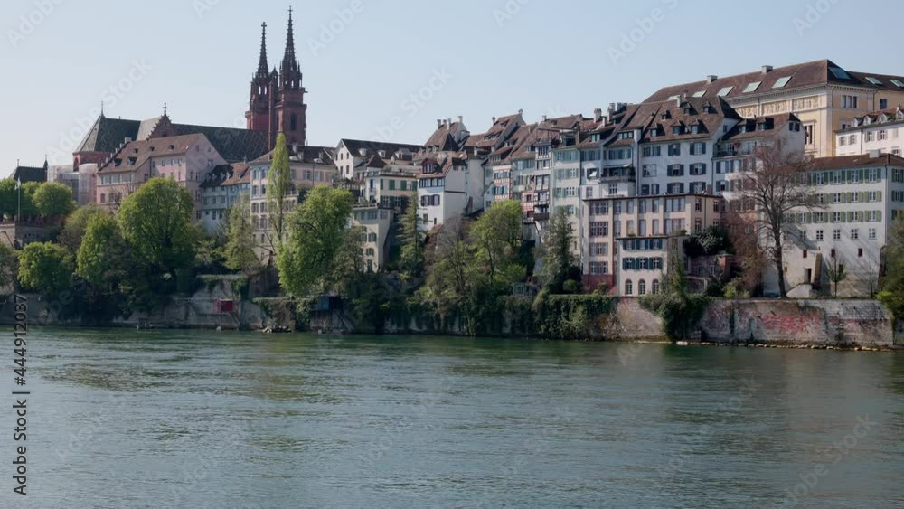 basel switzerland, april 24. 2021: view of the rhine in the foreground in the background old historic town hall and old town houses, summer day without people basel switzerland, april 24. 2021: view of the rhine in the foreground in the background old historic town hall and old town houses, summer day without people