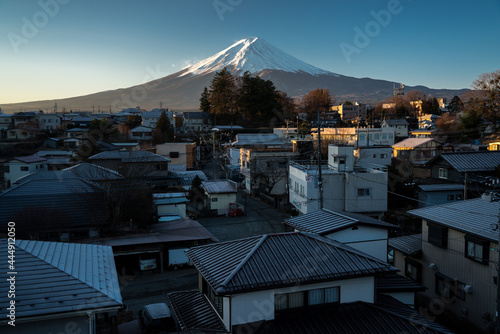 Morning view of Mount Fuji from Kawaguchiko town in Japan. Snow covered peak of Japan's highest mountain from a Japanese town. © Red Pagoda