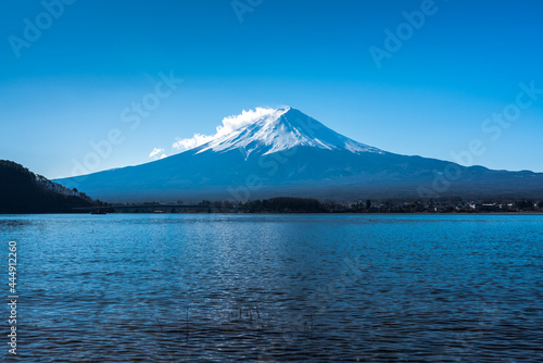 Mount Fuji from Lake Kawaguchiko in Japan. Clouds across the snow covered peak of Japan's highest mountain.