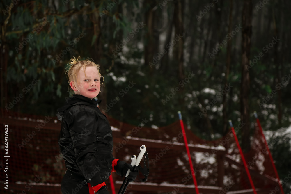 Young blonde boy playing in the snow at Mount Stirling, in the Victorian snow fields during the 2021 winter season Young blonde boy playing in the snow at Mount Stirling, in the Victorian snow fields during the 2021 winter season