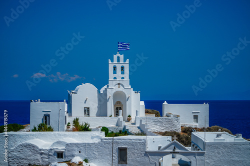 Stunning view of Chrisopigi Monastery white-washed building in Greece under a blue clear sky photo