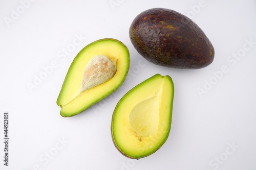 delicious fresh avocado halved isolated on white background	