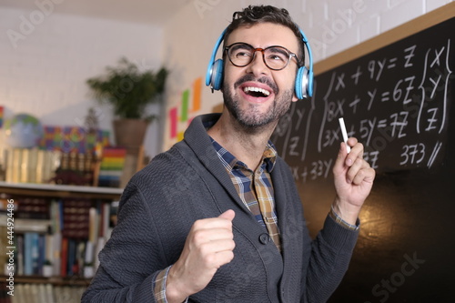 Teacher dancing with headphones in classroom