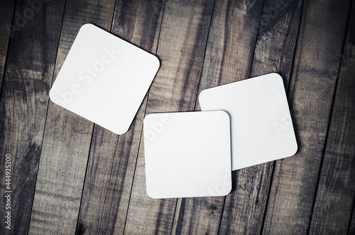 Photo of blank beer coasters on wooden background. Template for placing your design. Flat lay.