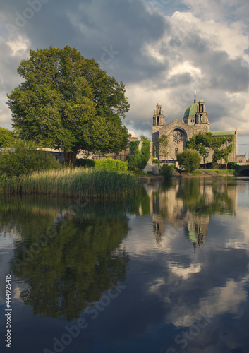 Beautiful scenery of Galway cathedral by the canal of Corrib river with reflecions in the water in Ireland 