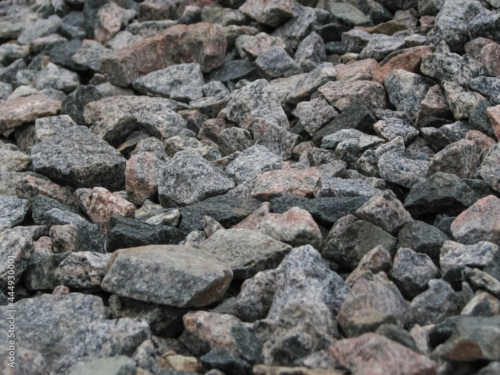 Unevenly laid wild stone of different colors and sizes Unevenly laid wild stone of different colors and sizes