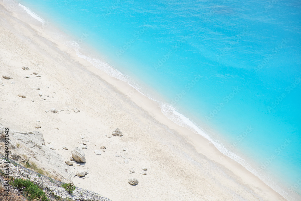 Obraz premium View from above on beautiful coast with white sand and aqua blue water and steep cliffs