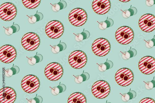 Colorful pattern with milk glasses and tasty cookies on a pastel green background. Uplifting morning creative idea.