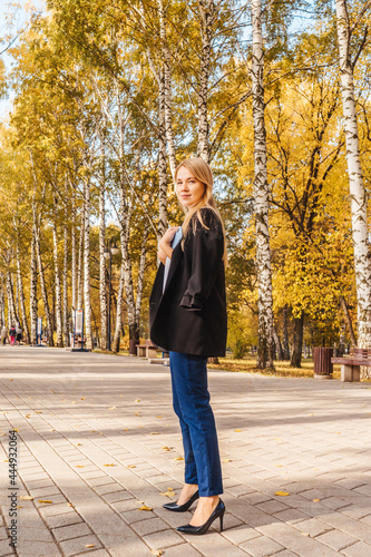 Business woman in black blazer in park. © Татьяна Максимова