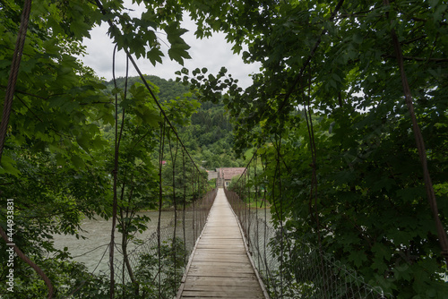 Suspension bridge across mountain river in Maramures