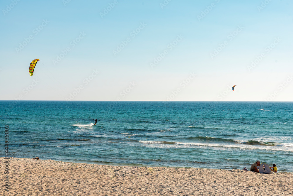 a group of people kite surfing